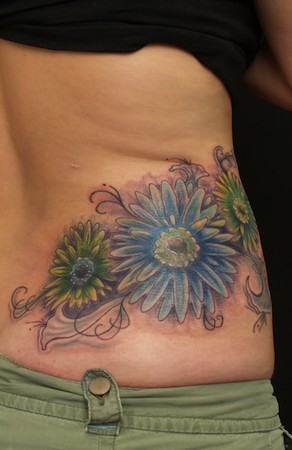 John Garancheski III - Flowers with filigree accents on side of back tattpp