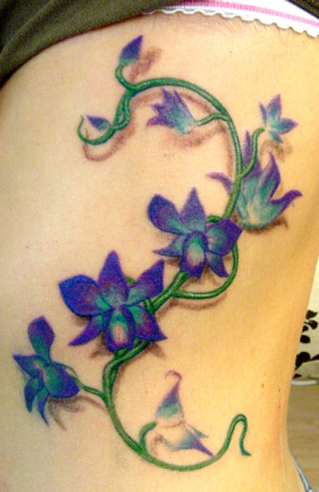 Avril Lavigne Rib Tattoo. flower vine tattoos.