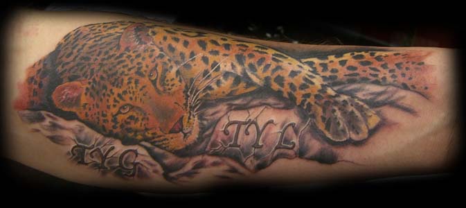leopard spots on arm tattoo