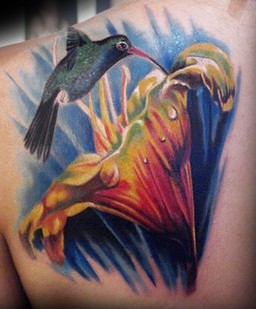 Hummingbird and flower shoulder tattoo