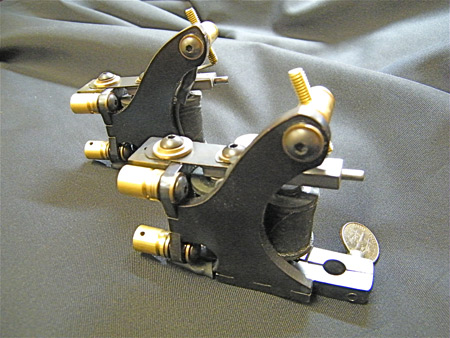 A unique vice grip setup on both tattoo machines where he cut a slot so the
