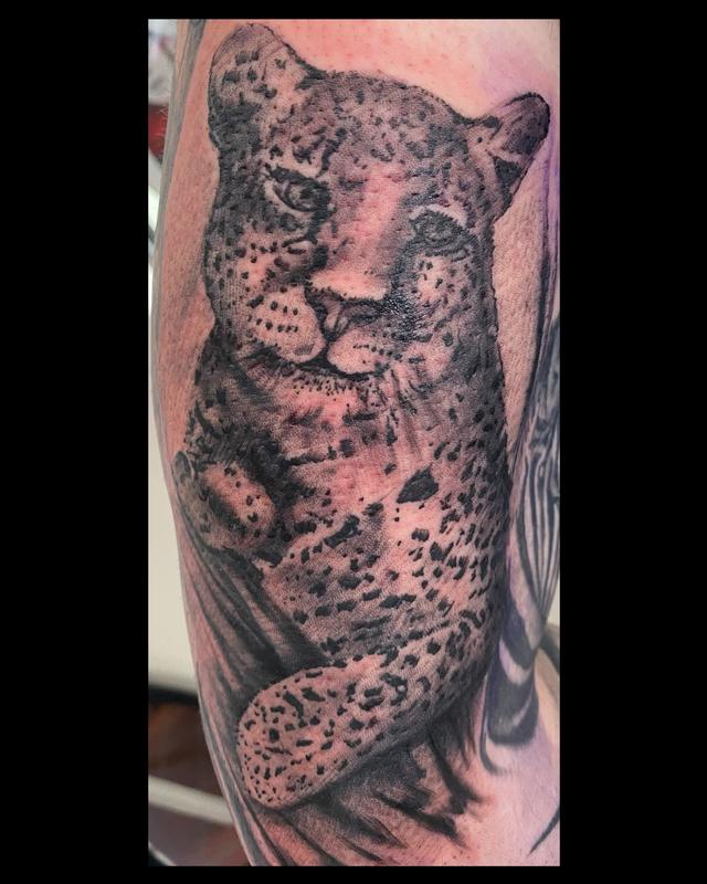 snow leopard tattoo arm