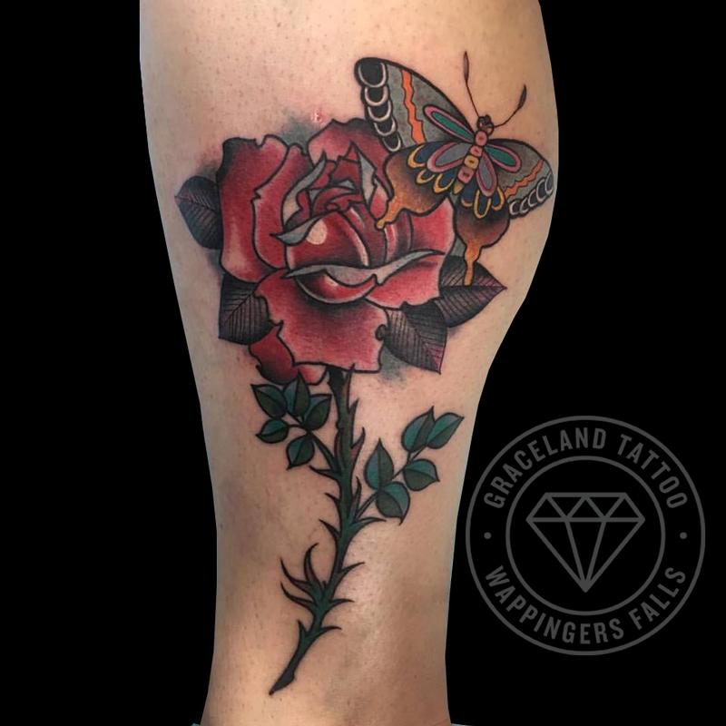 Butterfly and rose leg tattoo